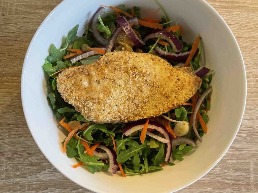 Chicken Breast coated with paleo breadcrumbs on a…